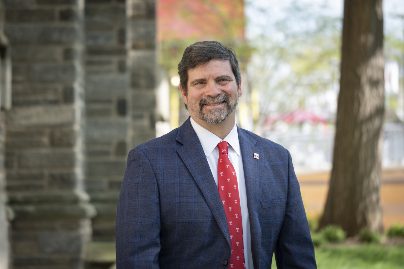 Josh Gladden standing outside on campus