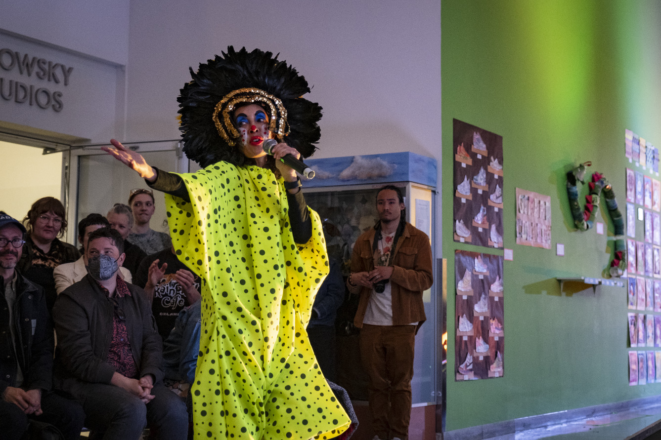 Host in an elaborate yellow and black costume