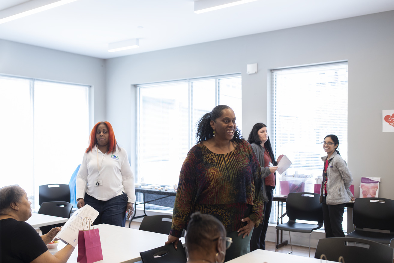 Image of a community health worker at Temple s breast cancer awareness event.