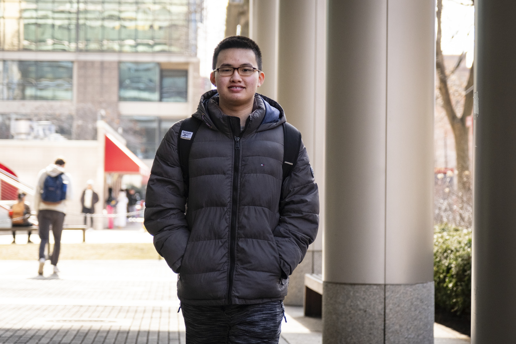 Edmond Tsan walks through campus