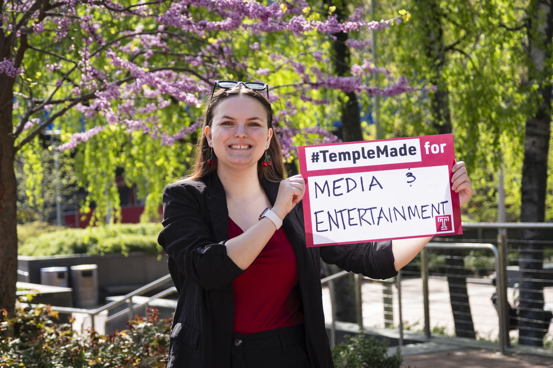 Image of Sydney Binkley holding a sign that reads