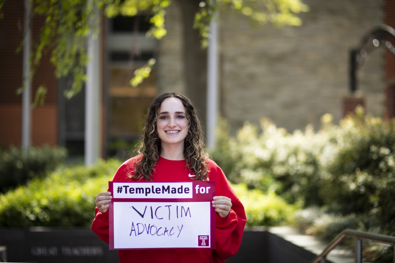 Ray Epstein holding a Temple Made for sign outside of Main Campus