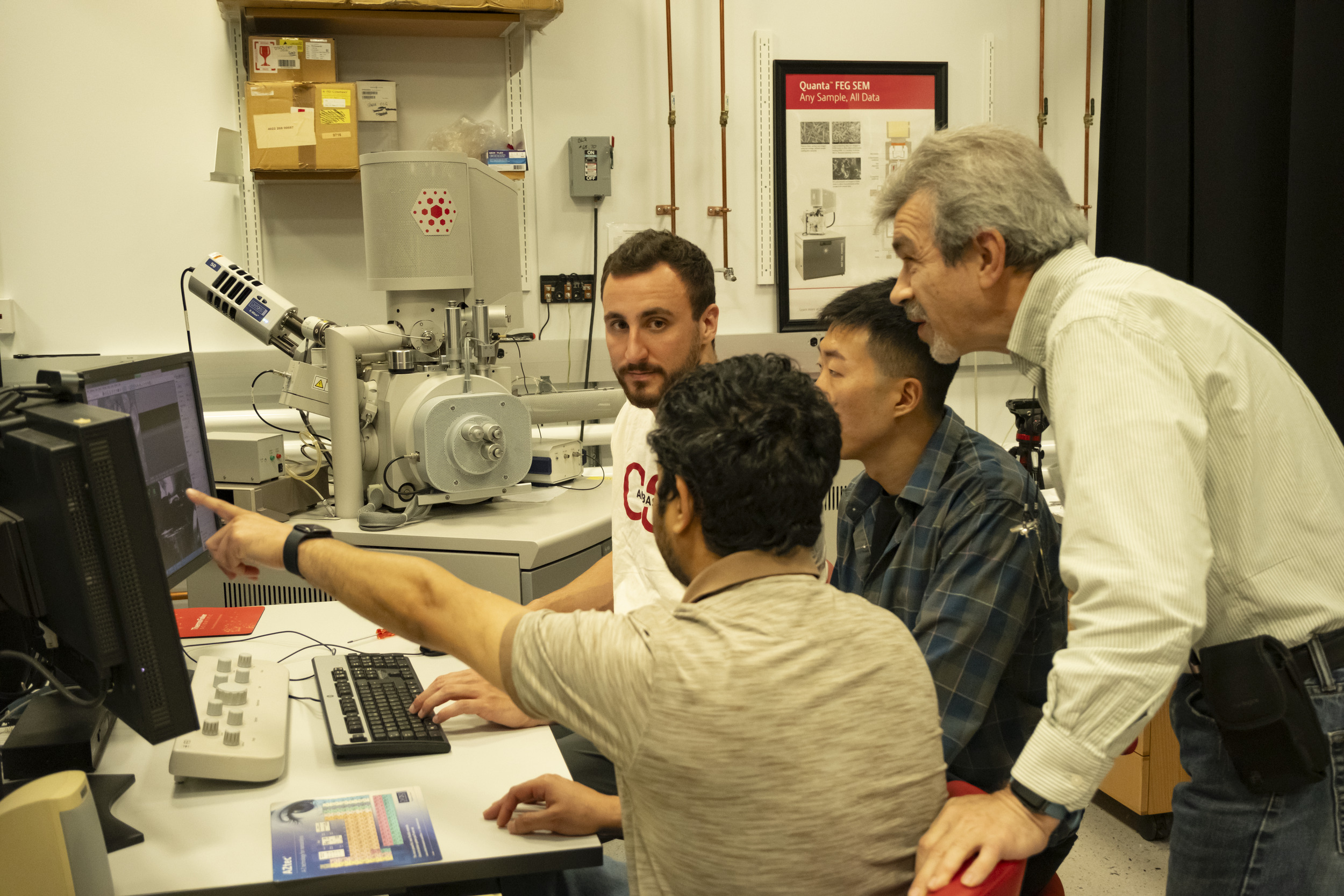 Image of Dmitriy Dikin working alongside researchers.