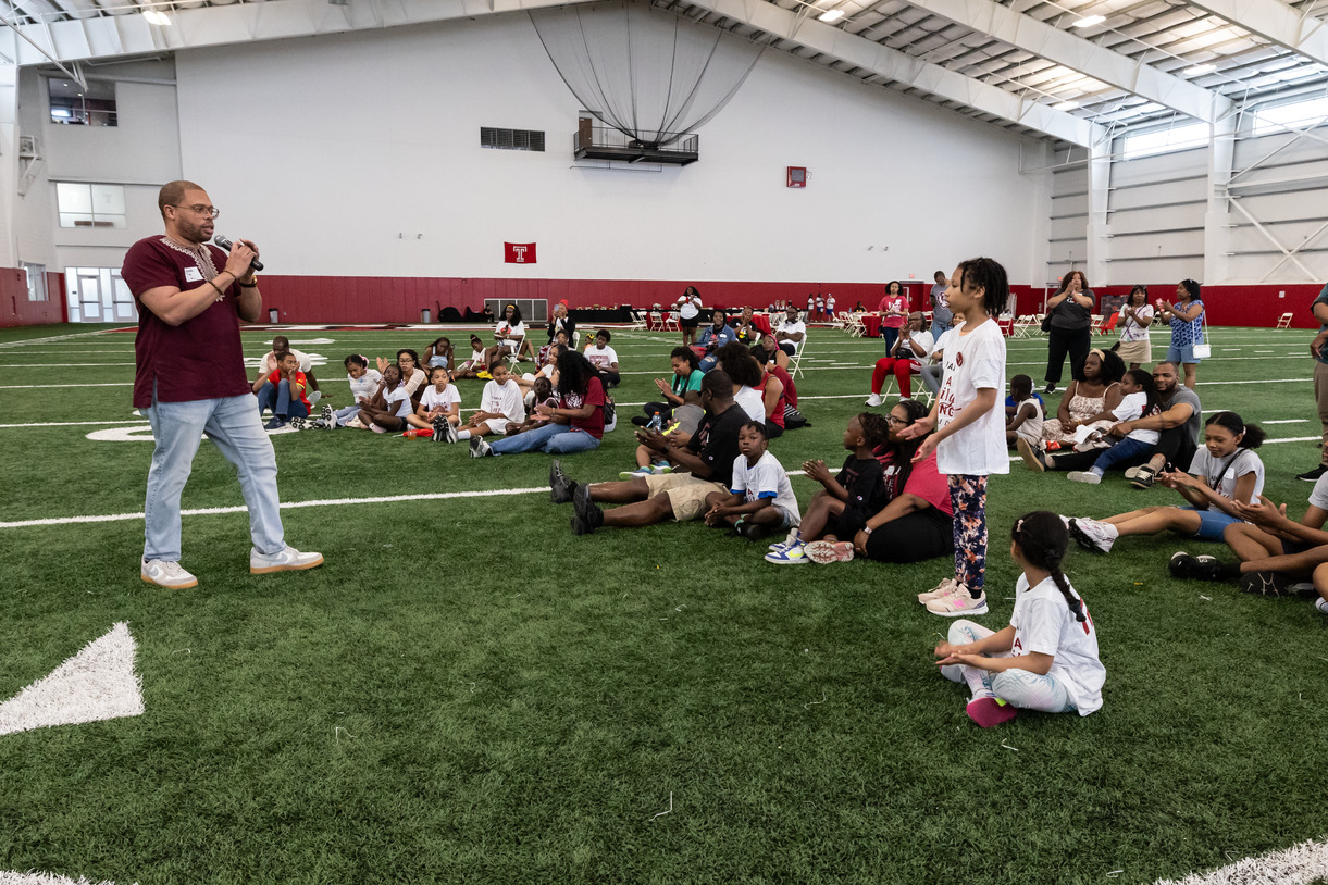 Image of Timothy Welbeck addressing the crowd at the Family Field Day event.