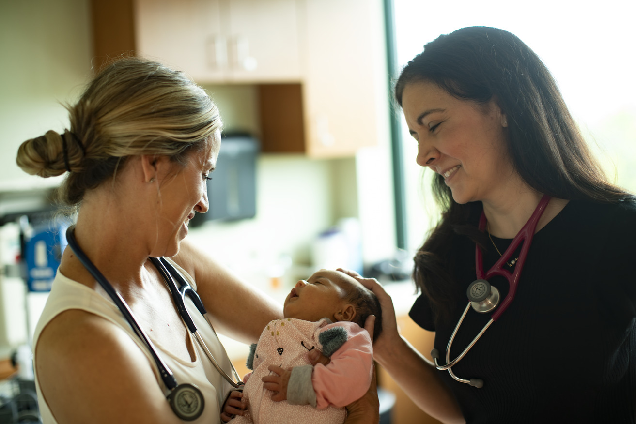 Female physicians with a baby