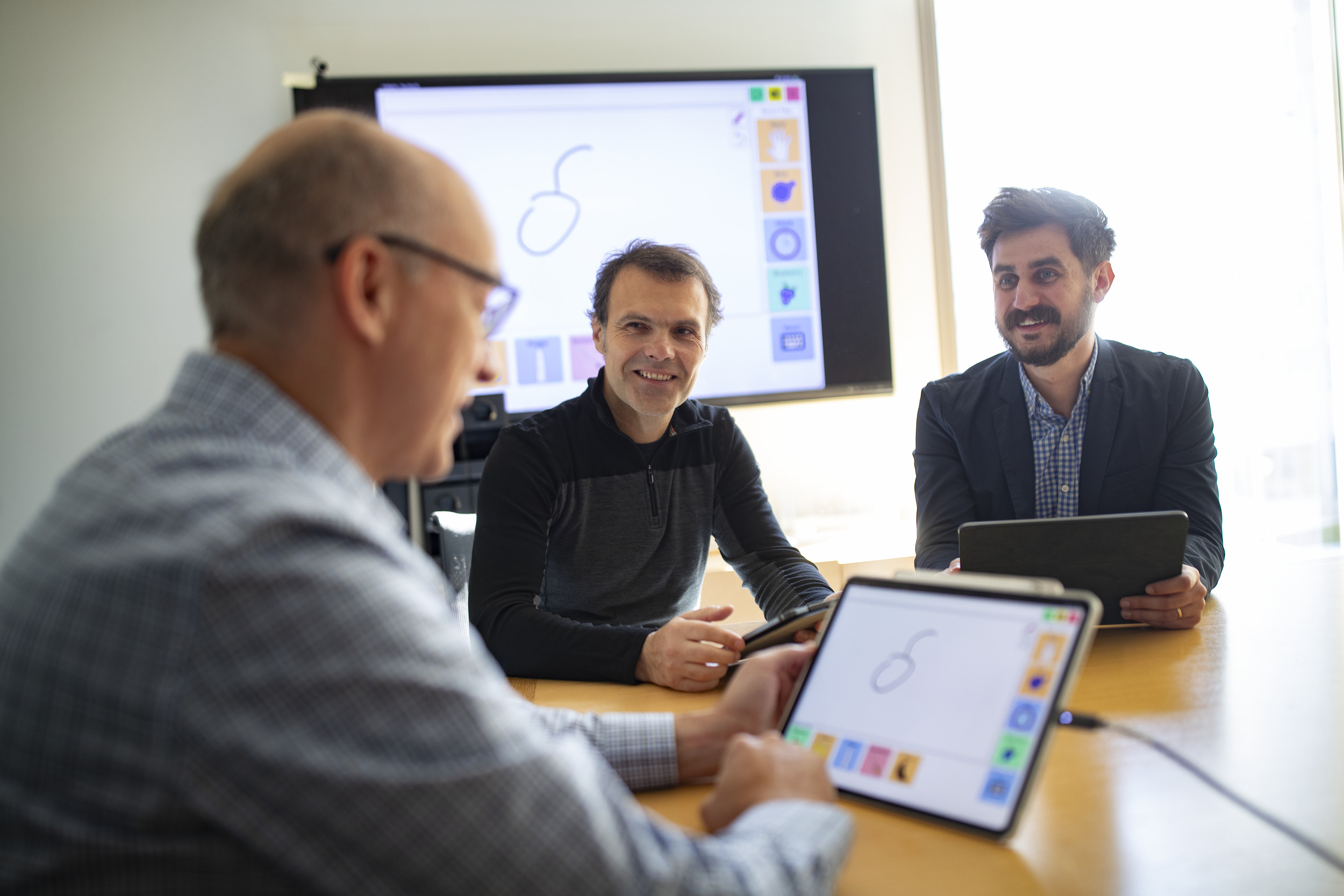 Image of Slobodan Vucetic, Eduard Dragut and Stephen MacNeil with one of their AAC devices.