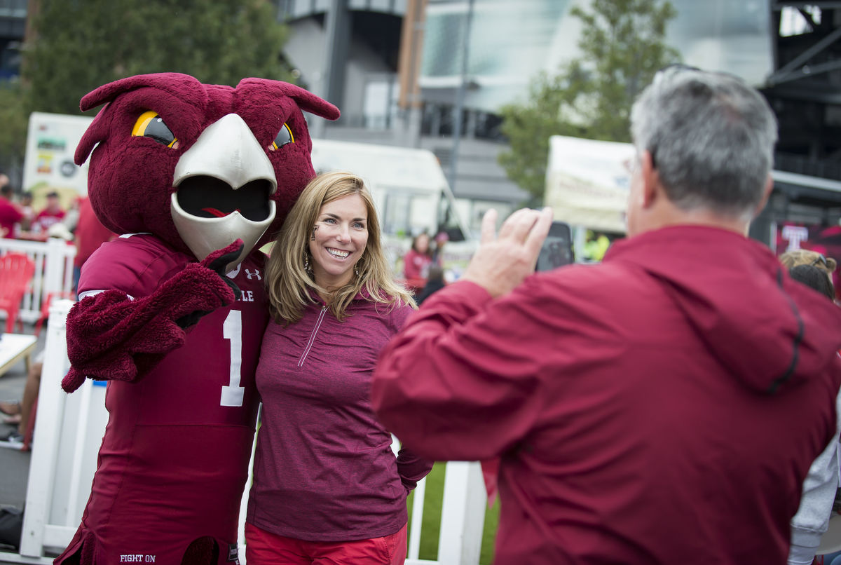 female alumna smiling with owl