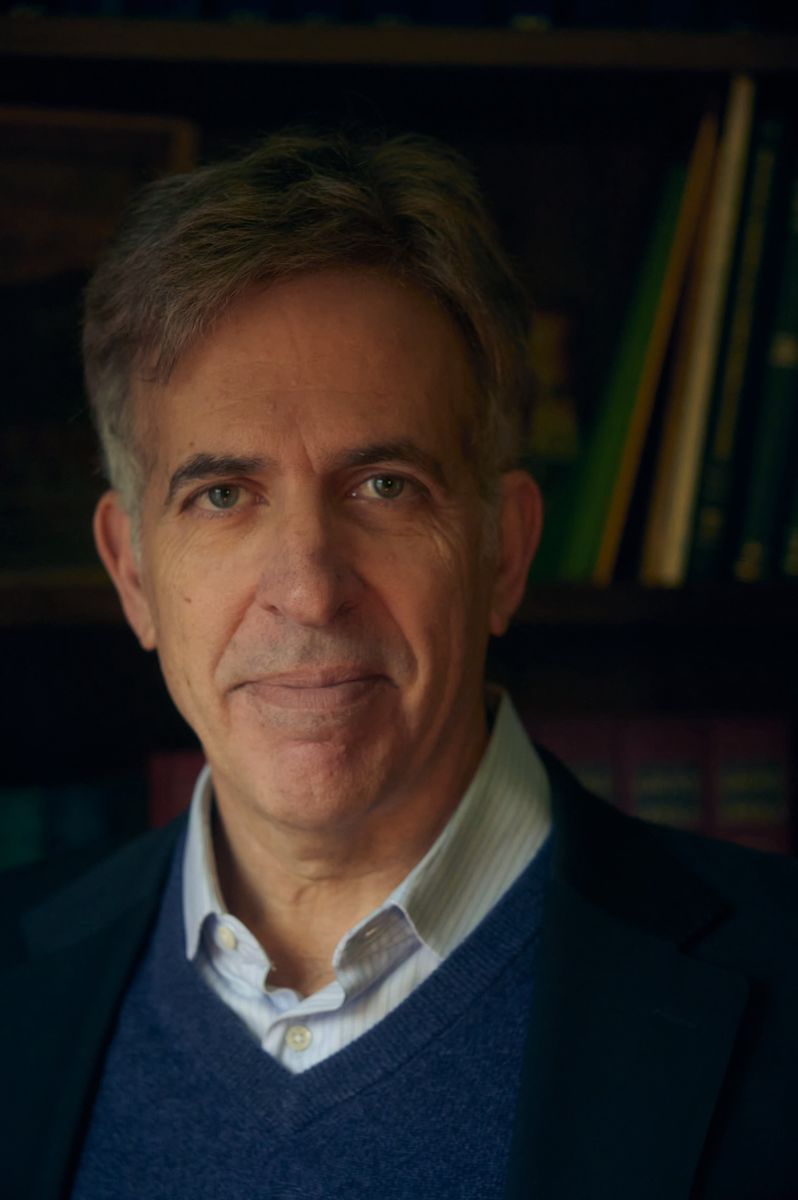 Photo of Dr. Lawrence Indik in front of a bookcase.