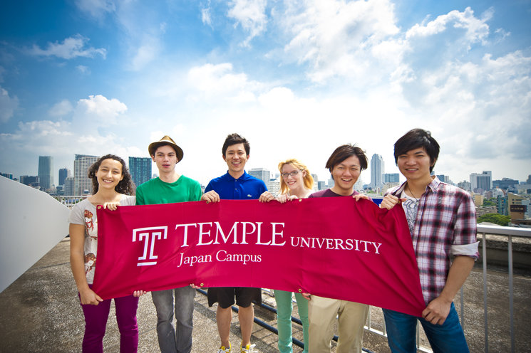 TUJ students holding TUJ flag