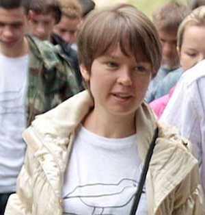 image of Yevgeniya Chirikova standing in a crowd wearing a white tee shirt and cream jacket