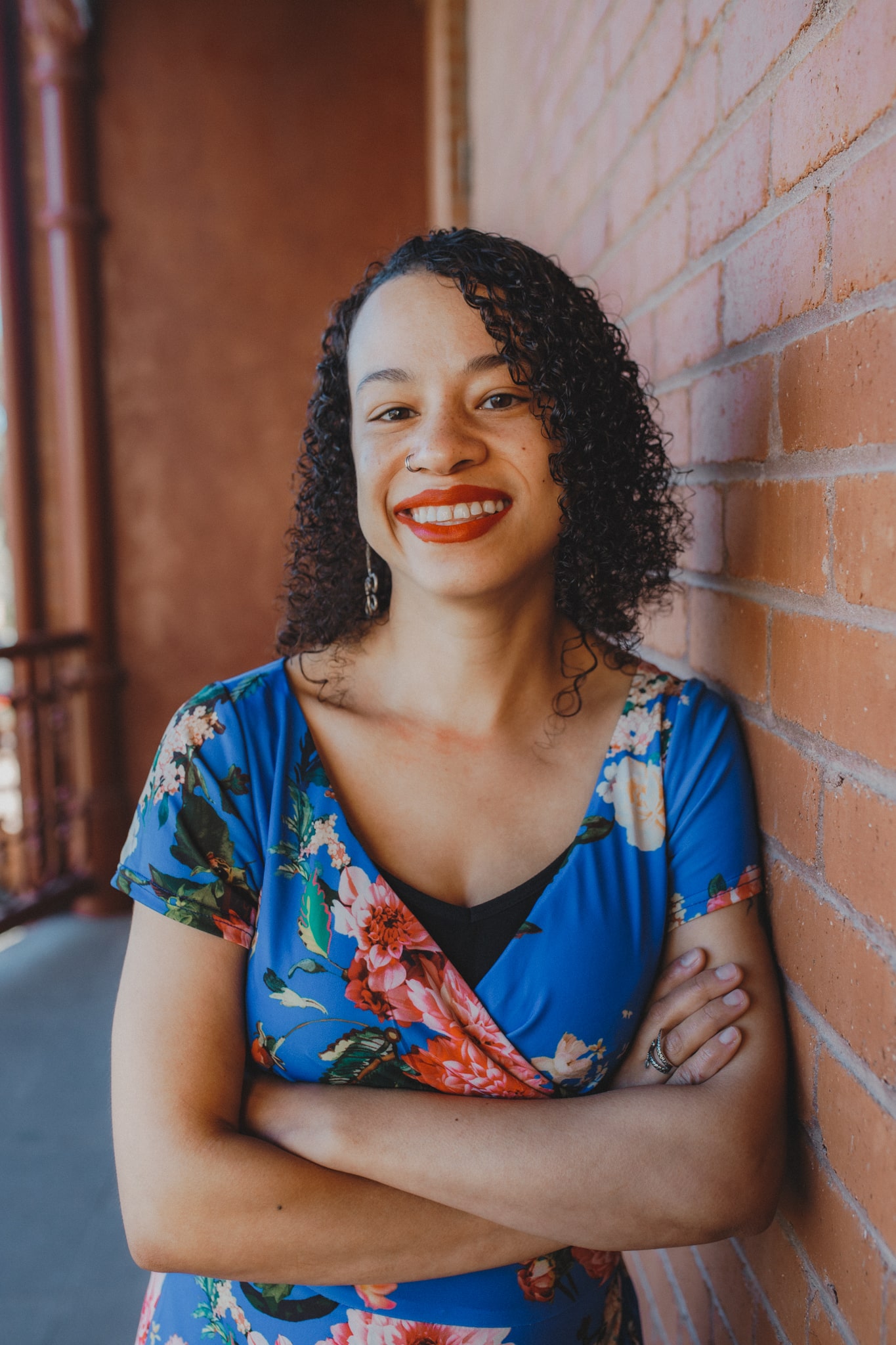 Image of Carissa Harris standing in a floral-printed outfit.