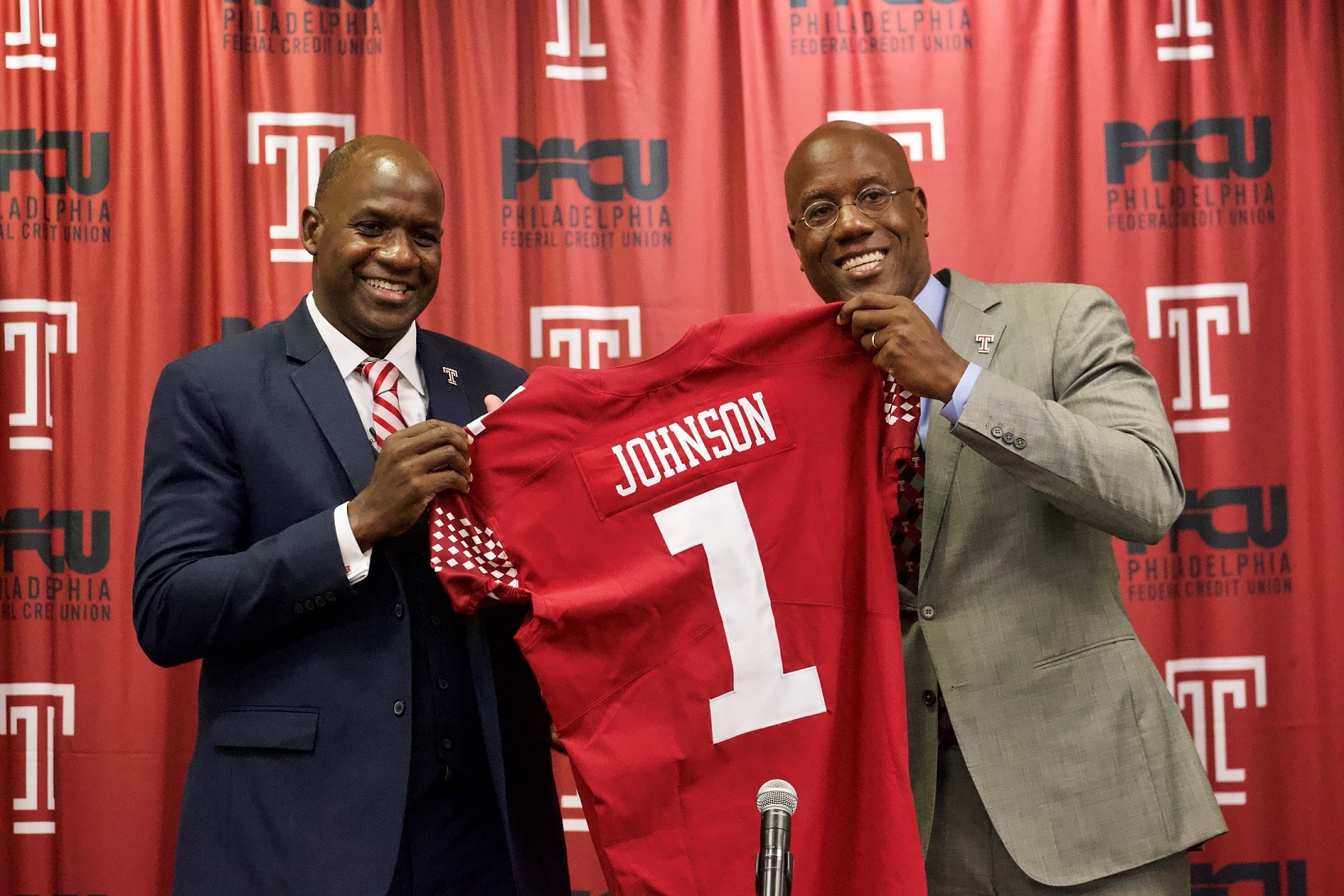 Arthur Johnson pictured with President Wingard, holding Johnson's replica Temple jersey.