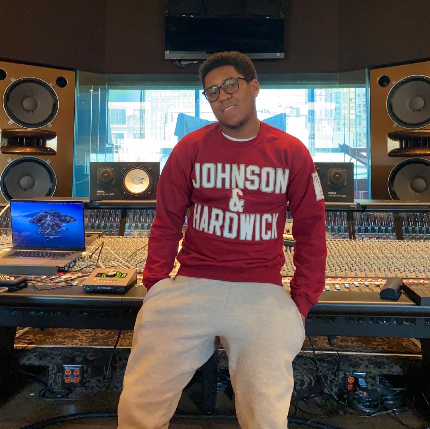 Ben Thomas wearing a Johnson & Hardwick sweatshirt in a studio