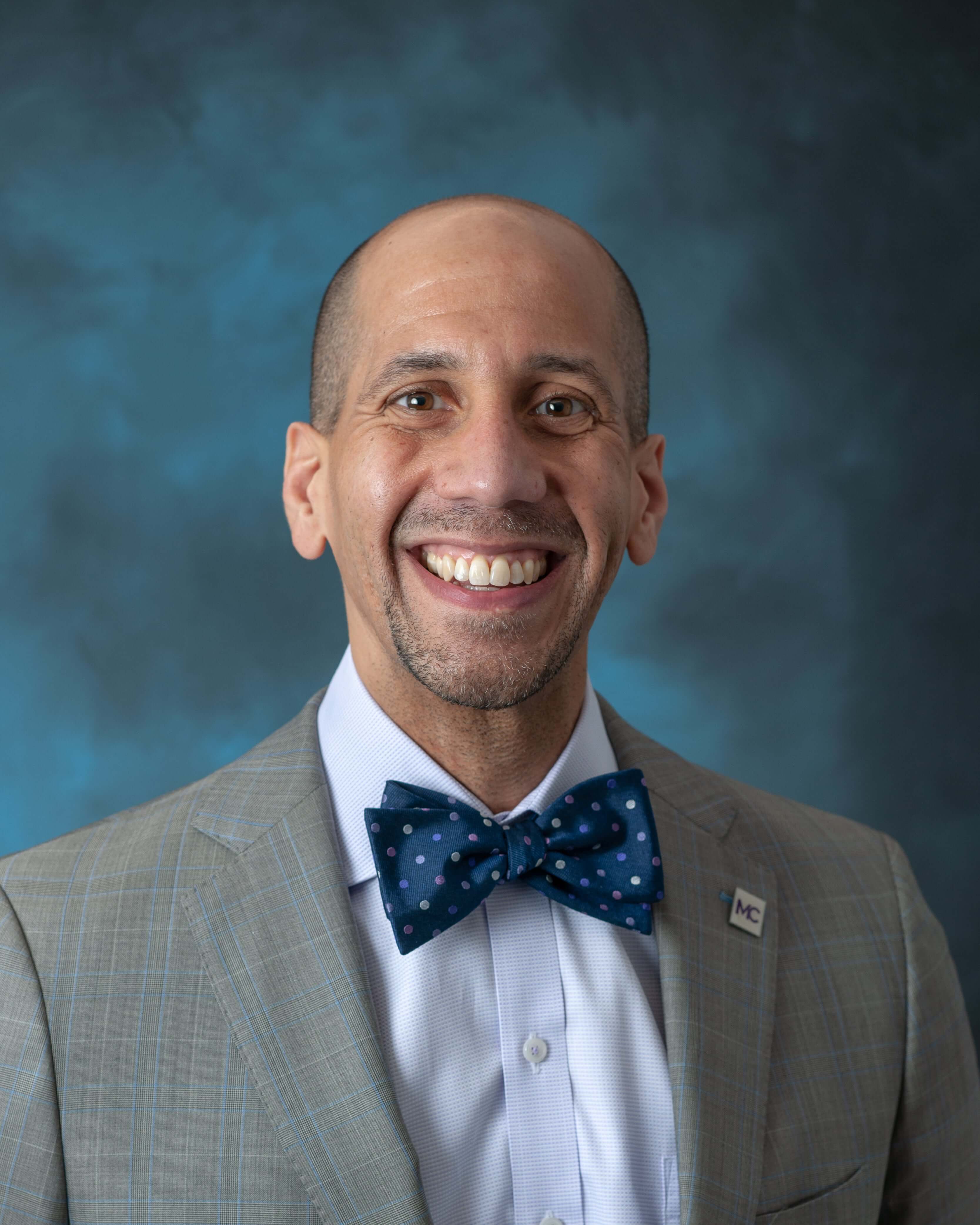 Image of Jermaine F. Williams in front of a blue background