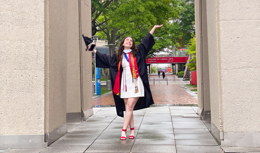 Roth poses in cap and gown at the Bell Tower