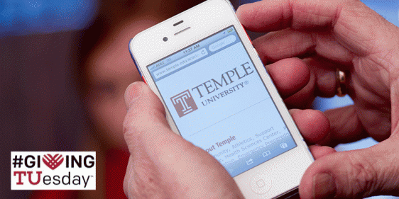 A donor using a mobile device to give to Temple.