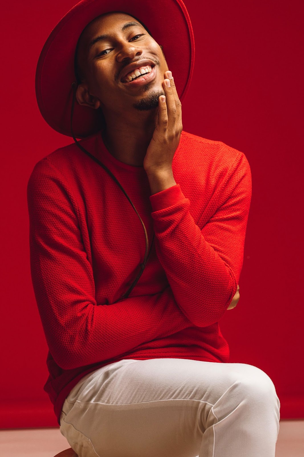 Kalen Allen posing in red.