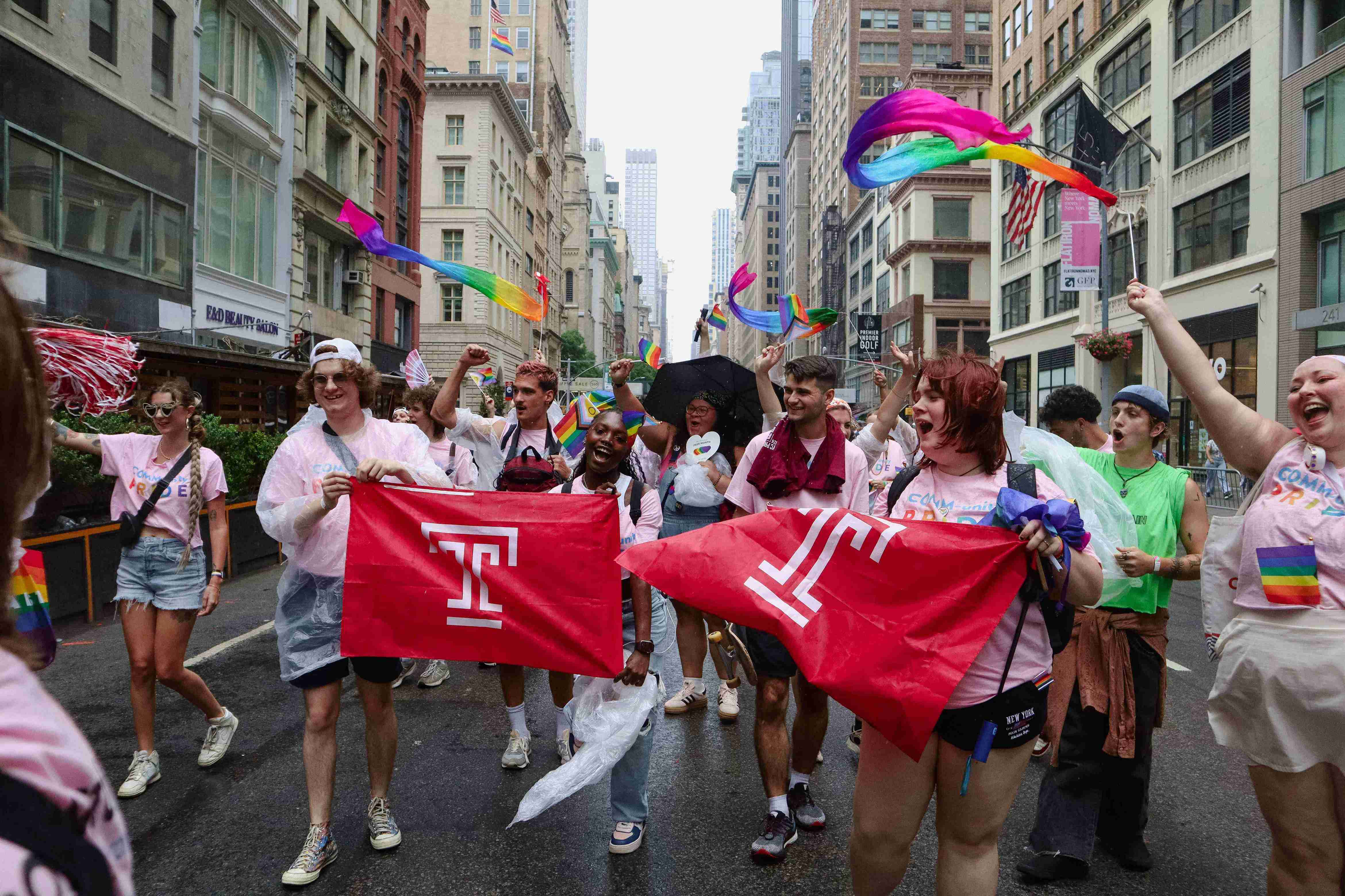 Students holding Temple flags at NYC Pride