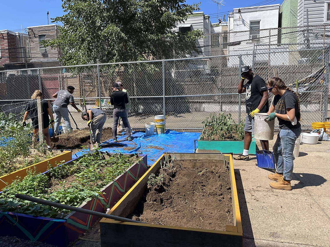 Students outside working on a garden.