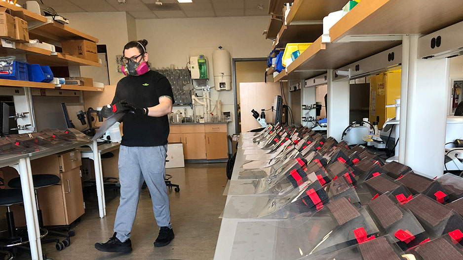 student organizing face shields for delivery