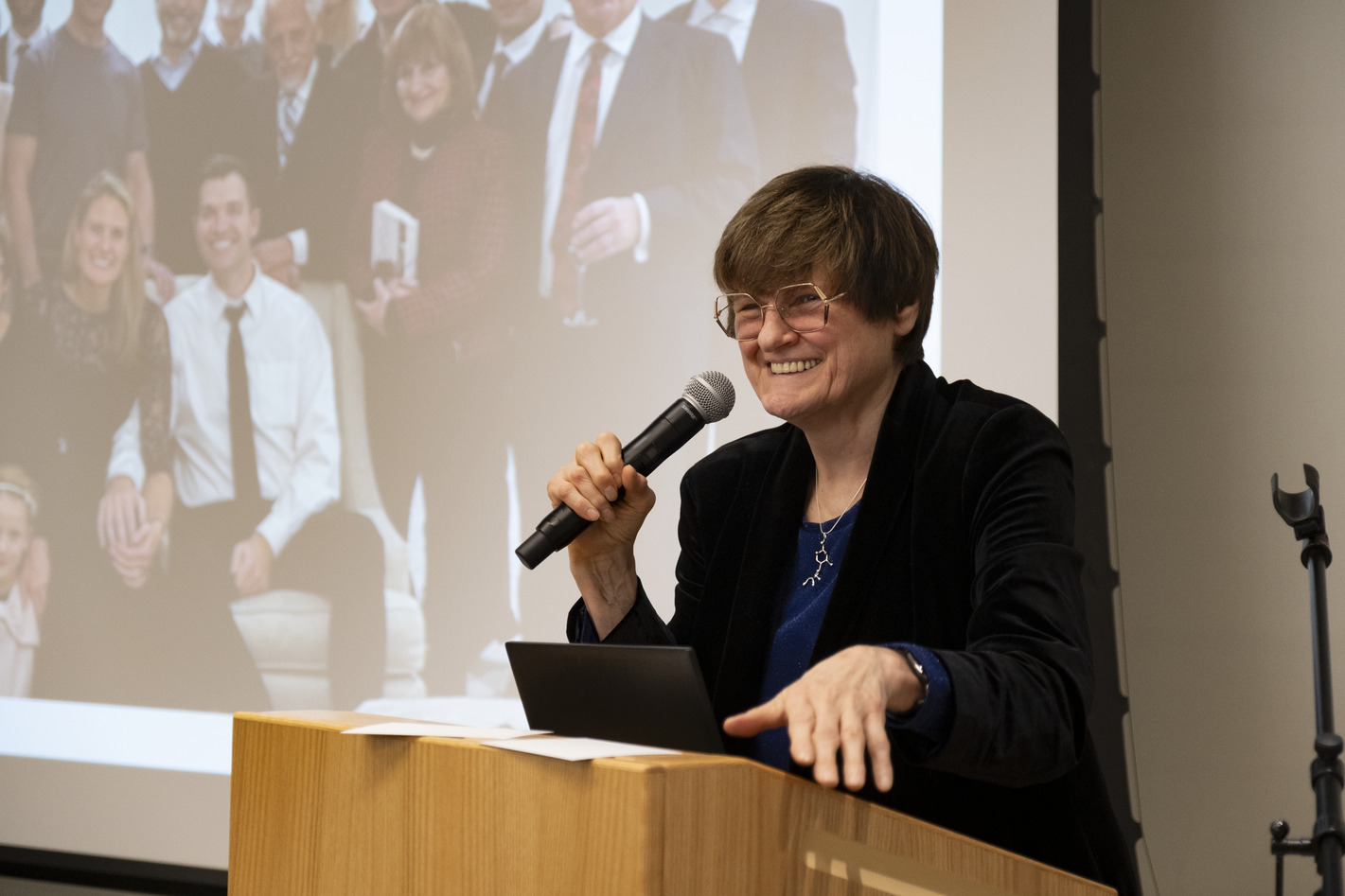 Dr. Kariko standing and speaking at a podium