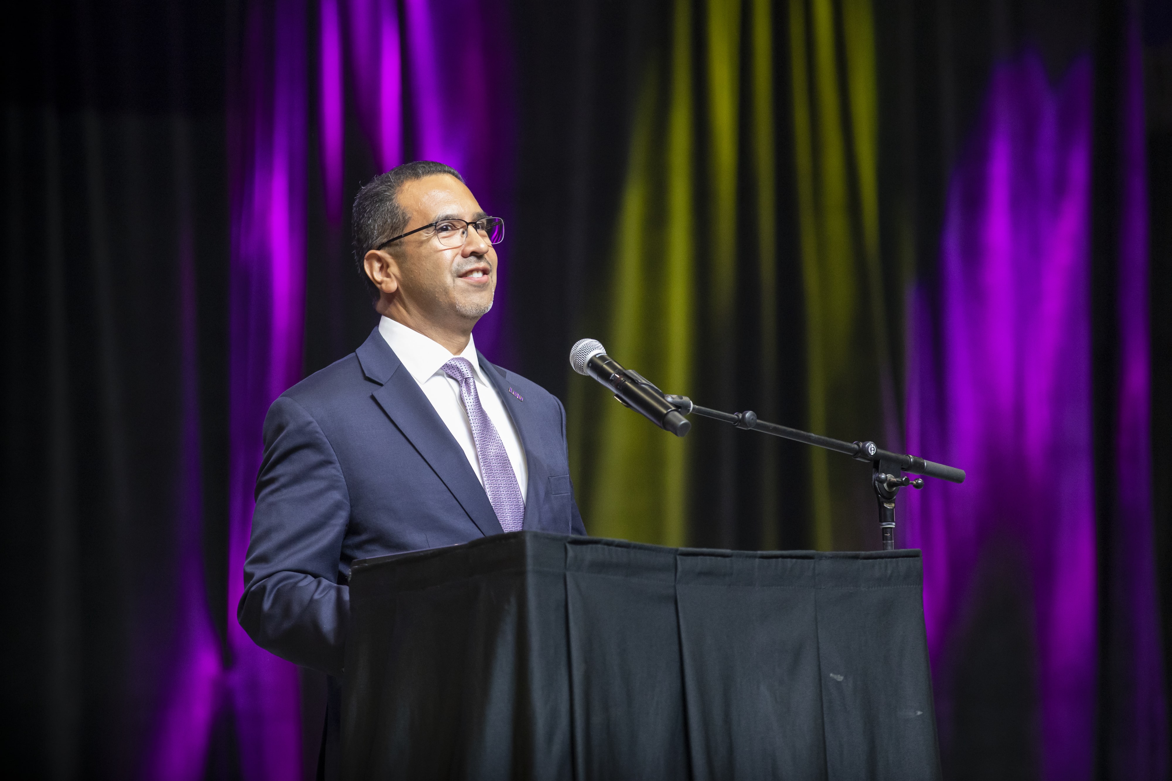 Jose Aviles speaking at a podium