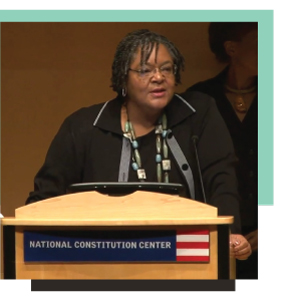 Maida Odom talking at a podium