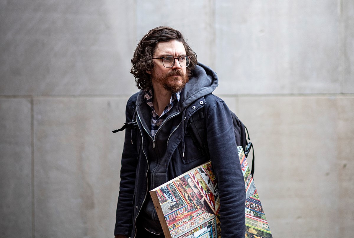 Mat Tomezsko holding the collage example piece for Revolutionary Philadelphia.