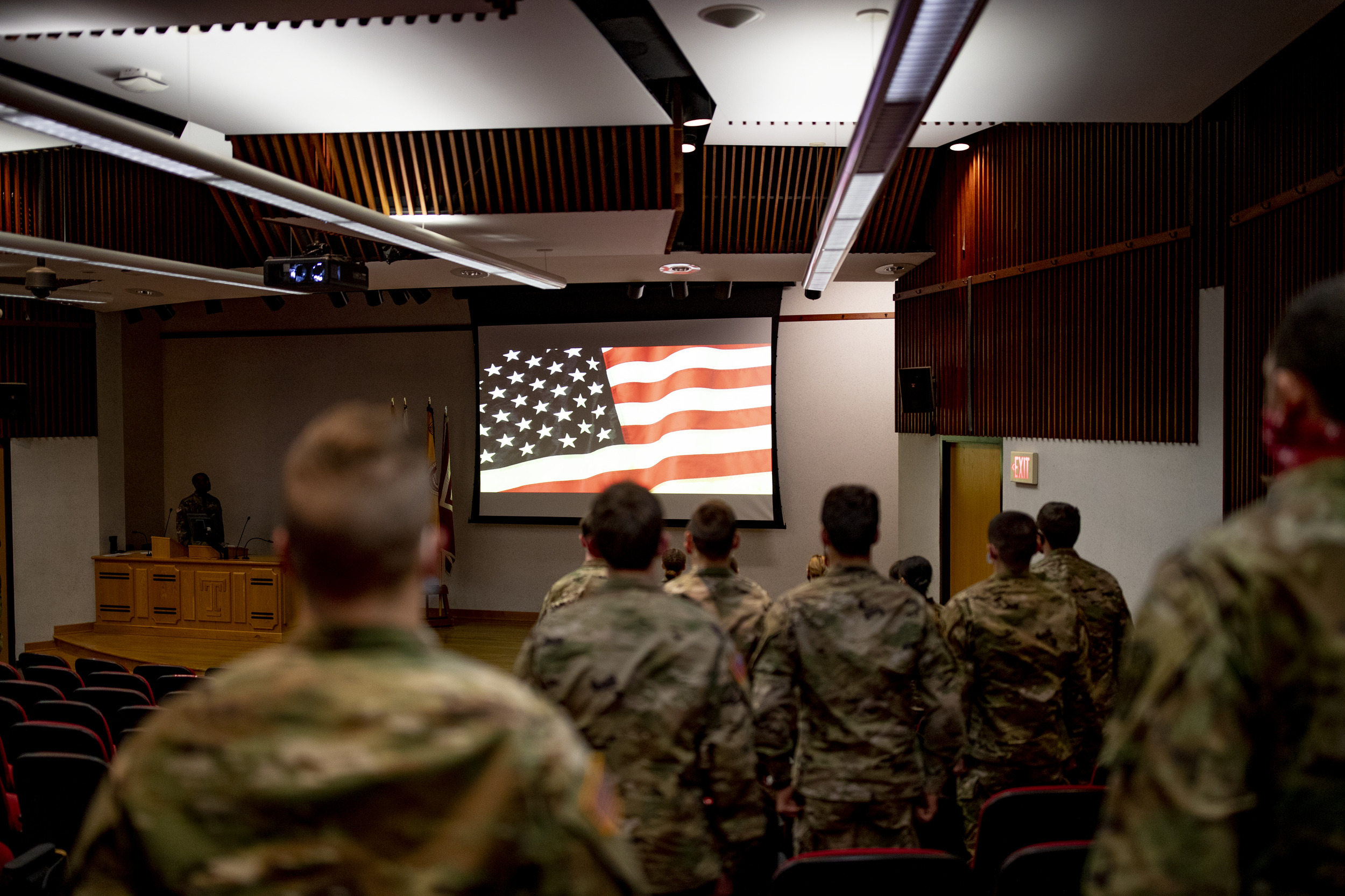 Military students saluting the flag