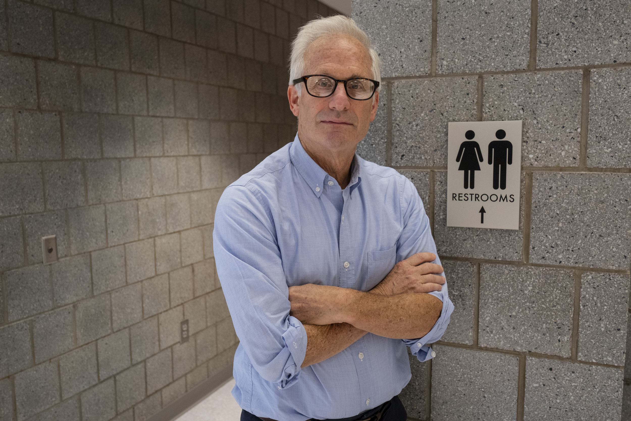 A photo of Bryant Simon outside a public restroom.