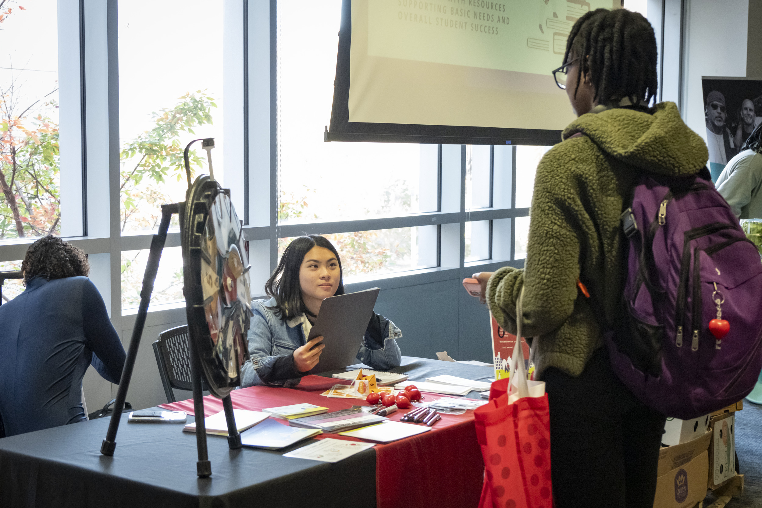 WRC peer educator speaking with a student at a resource fair
