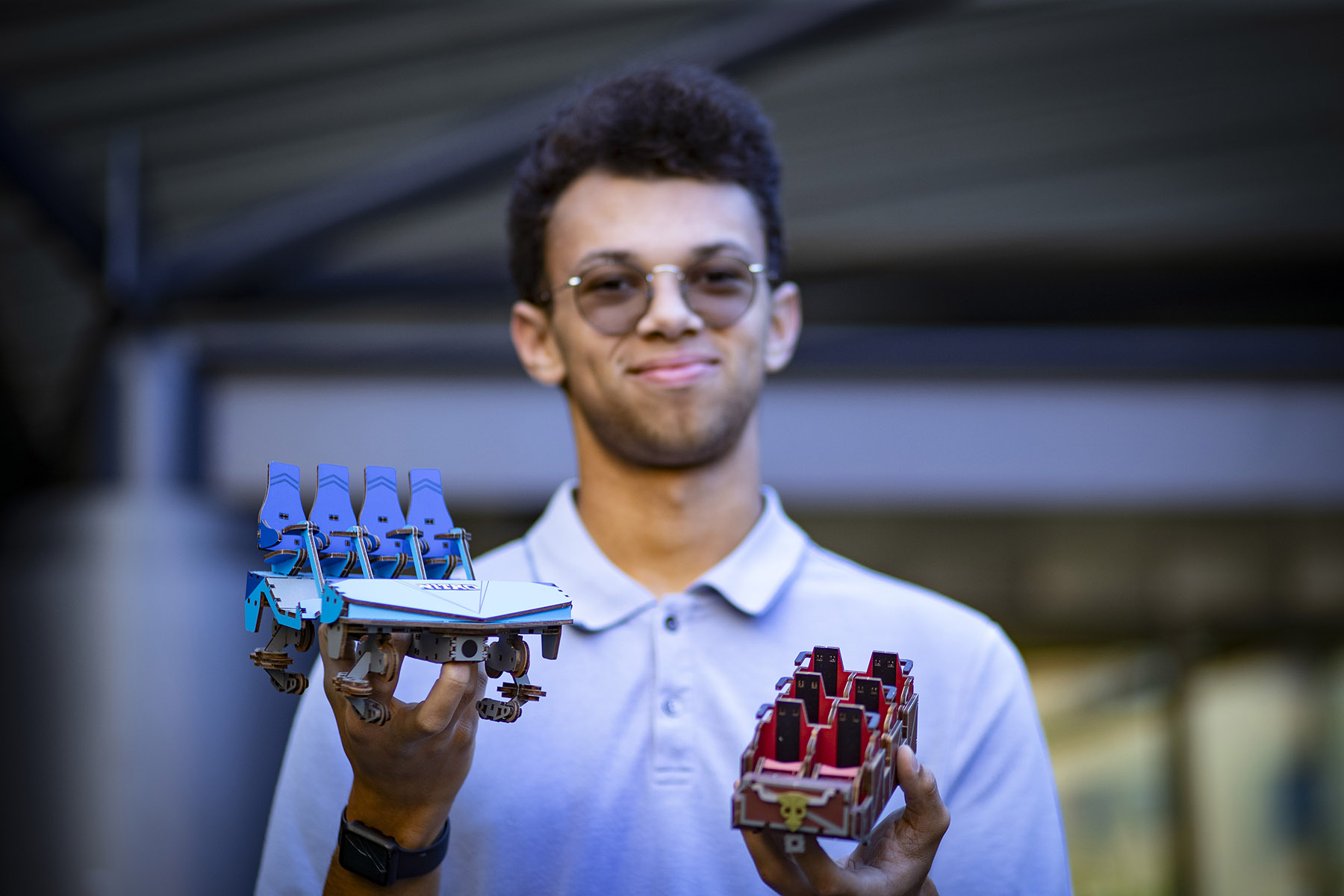 Johns holds two roller coaster model cars