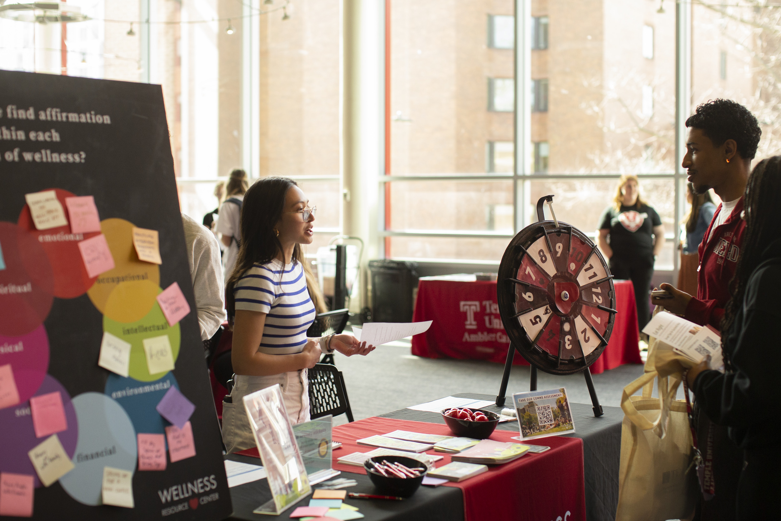 WRC peer educator talks with students at the self-care fair