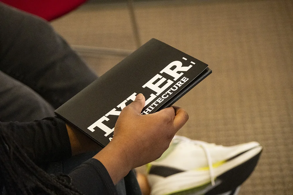 closeup of a student holding Tyler admissions print materials