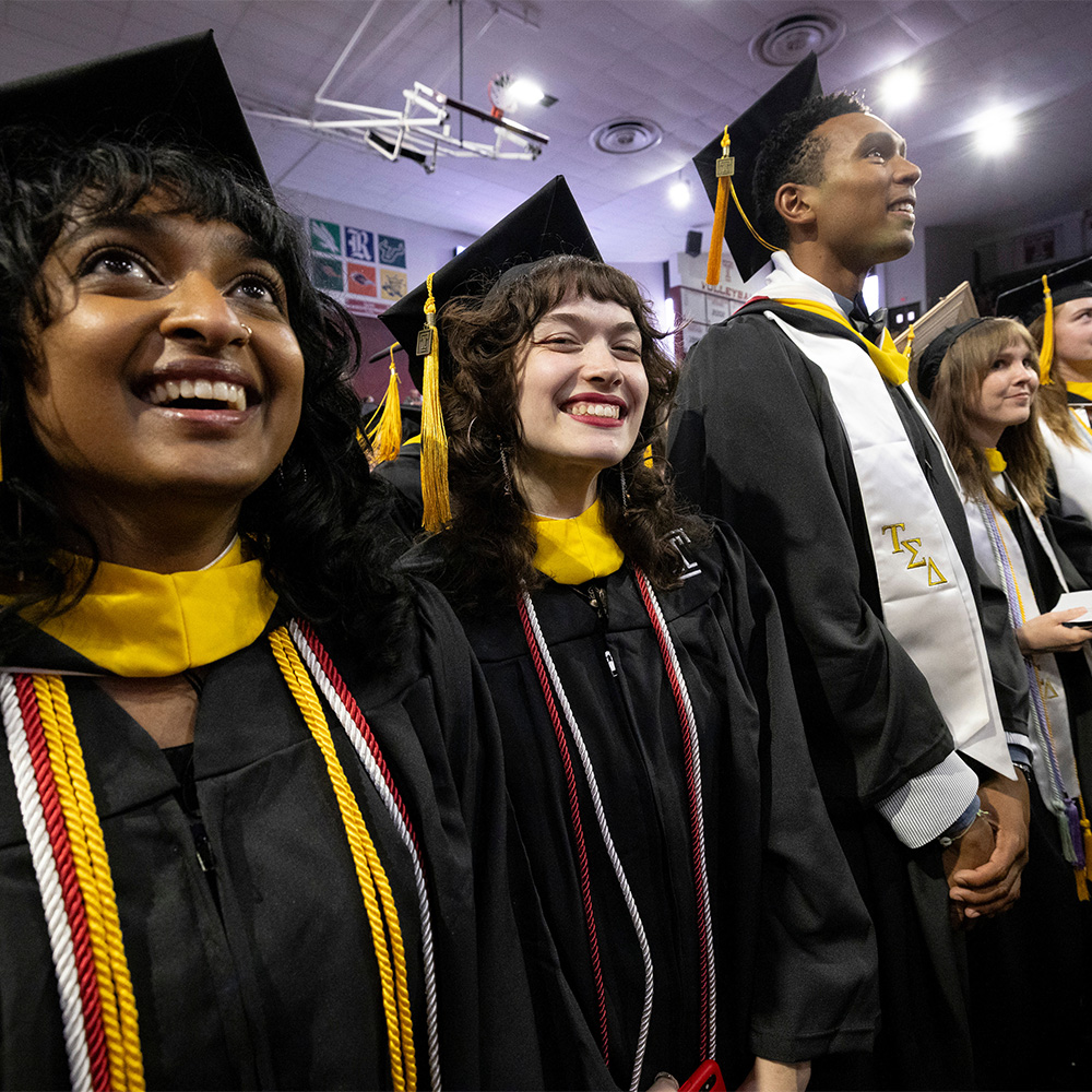 students standing in attendance of the 2025 graduation ceremony