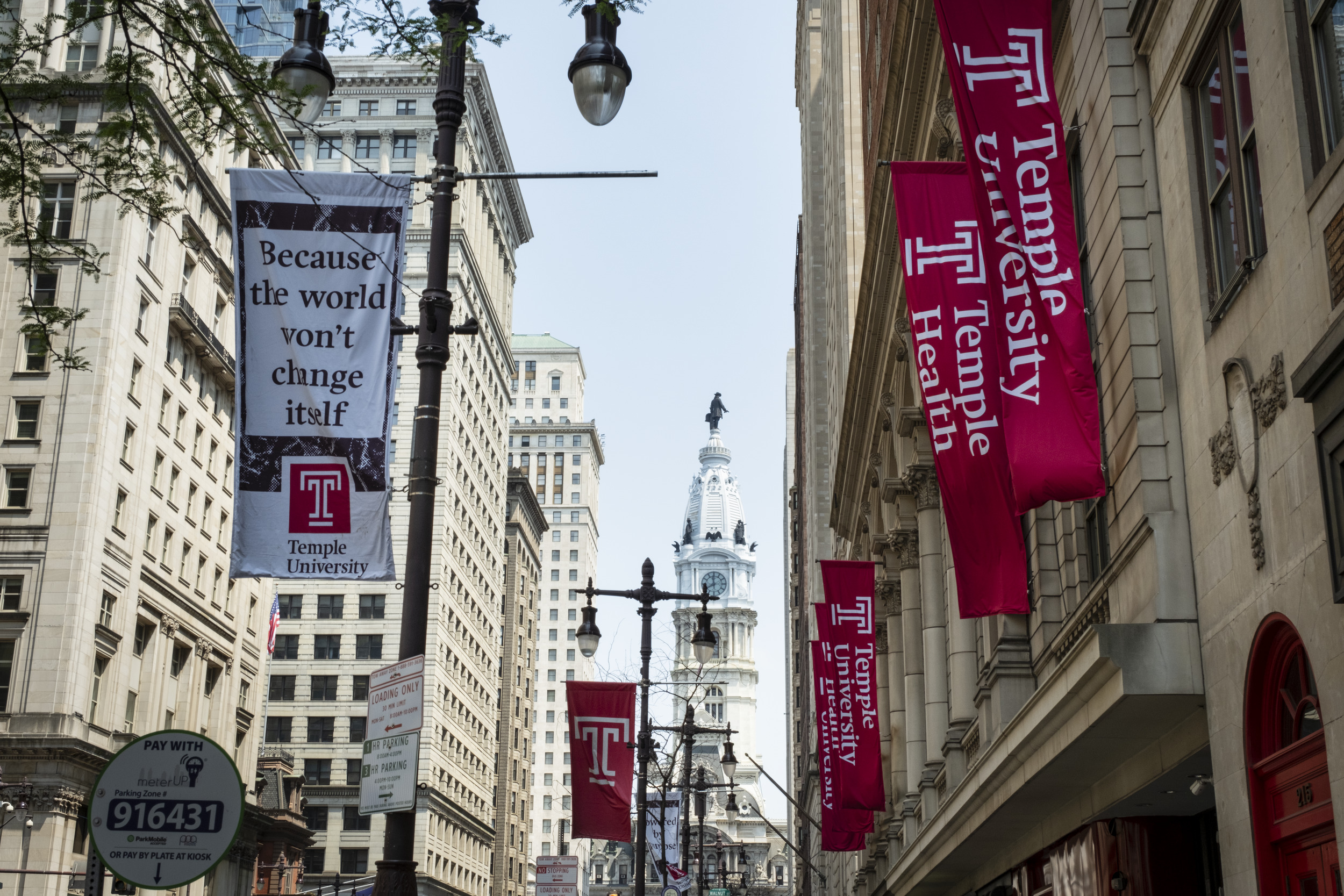 a picture of the street between terra hall and the street with temple banners hanging down