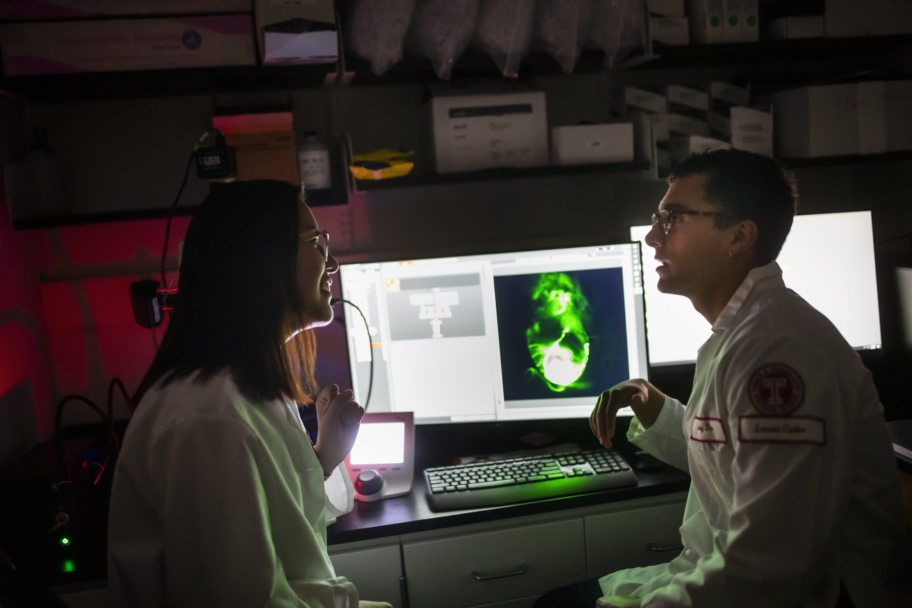 Image of two Temple researchers in front of a computer screen.