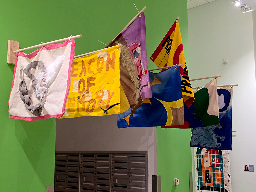 community-created flags hang in the Tyler Atrium