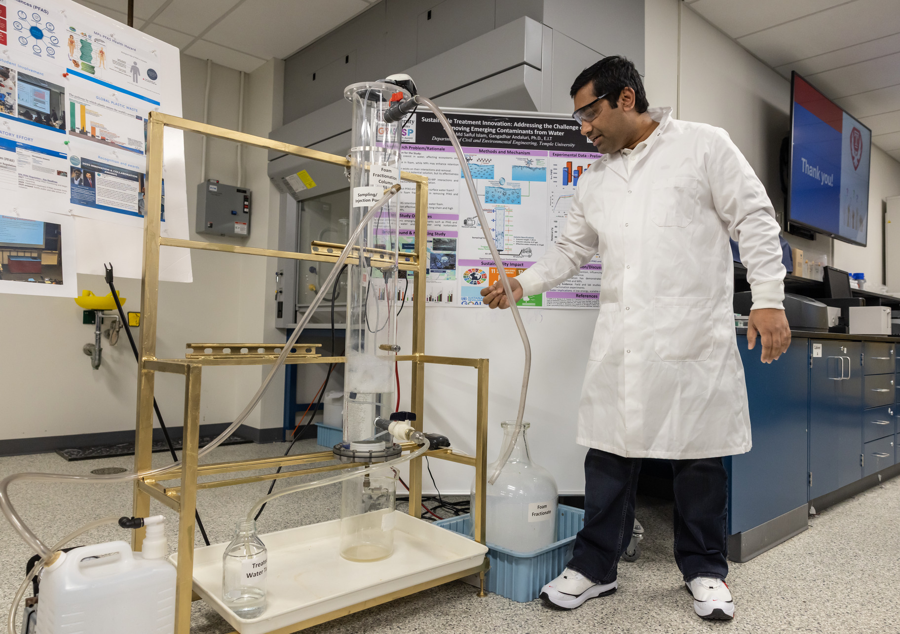 Image of Md Saiful Islam demonstrating his foam fractionation system at the College of Engineering.
