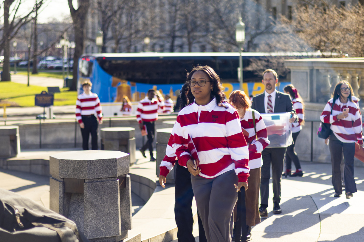 Temple students wearing red-and-white striped rugby-style shirts at Owls on the Hill
