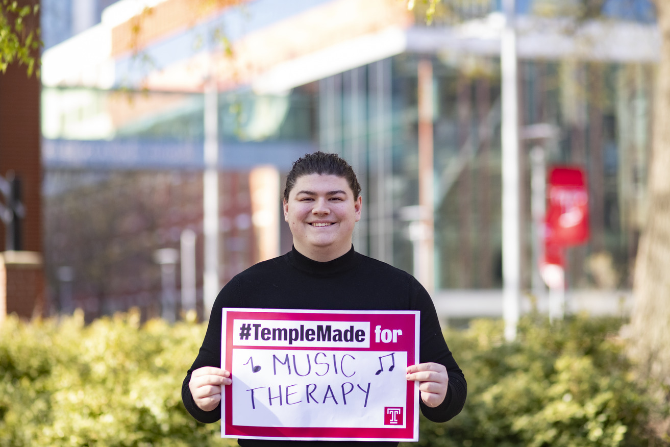 Gabriel holding a sign