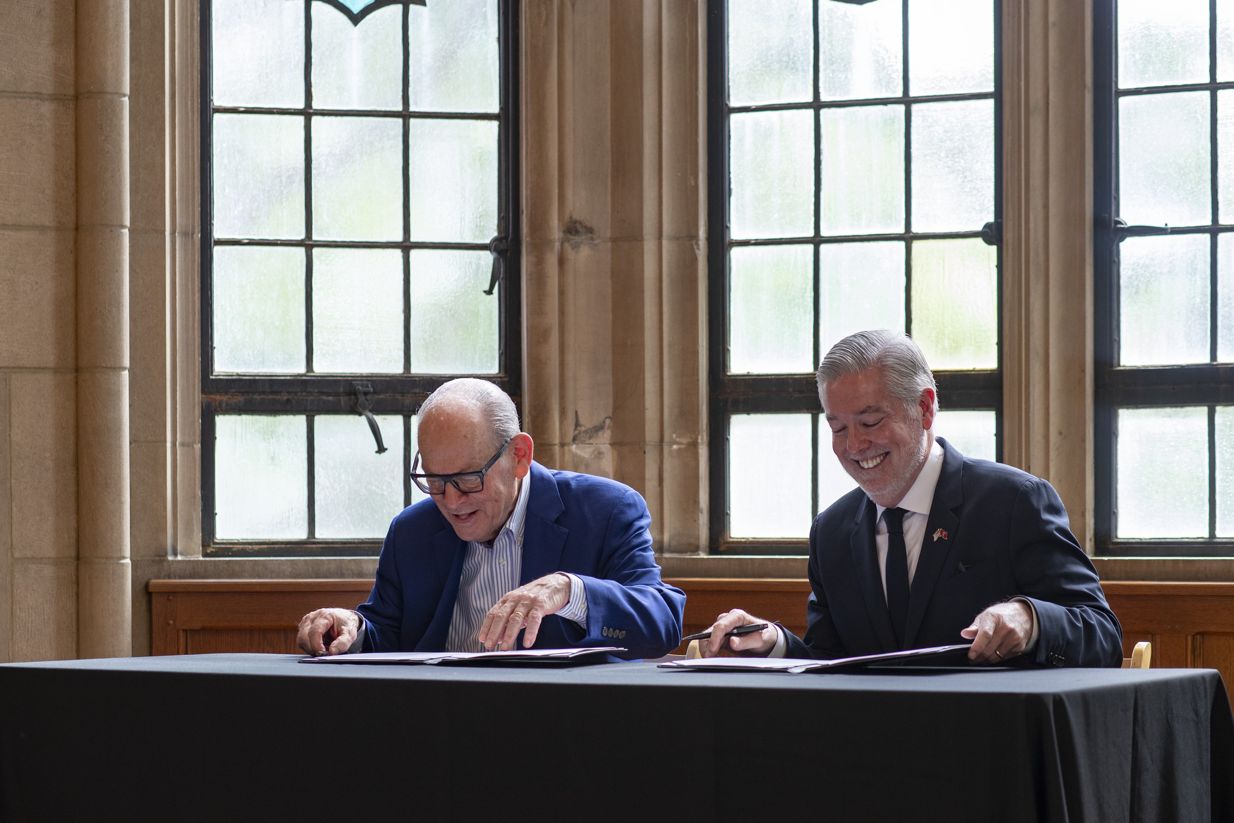 Joe Neubauer and President Fry signing a gift agreement.