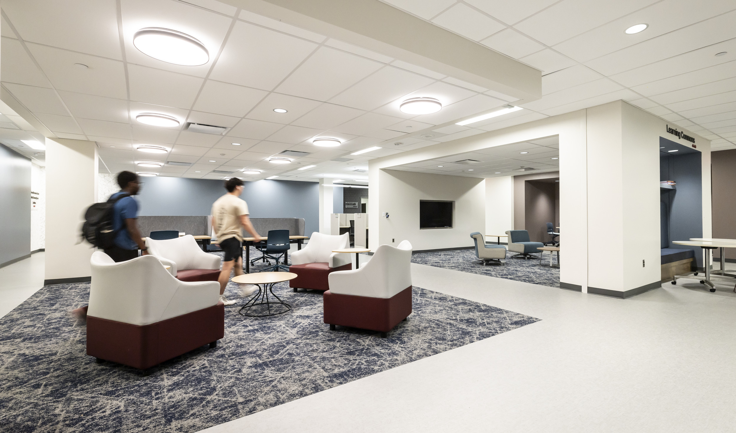 Students walking inside of the Christopher and Julie Barnett Essential Needs Hub