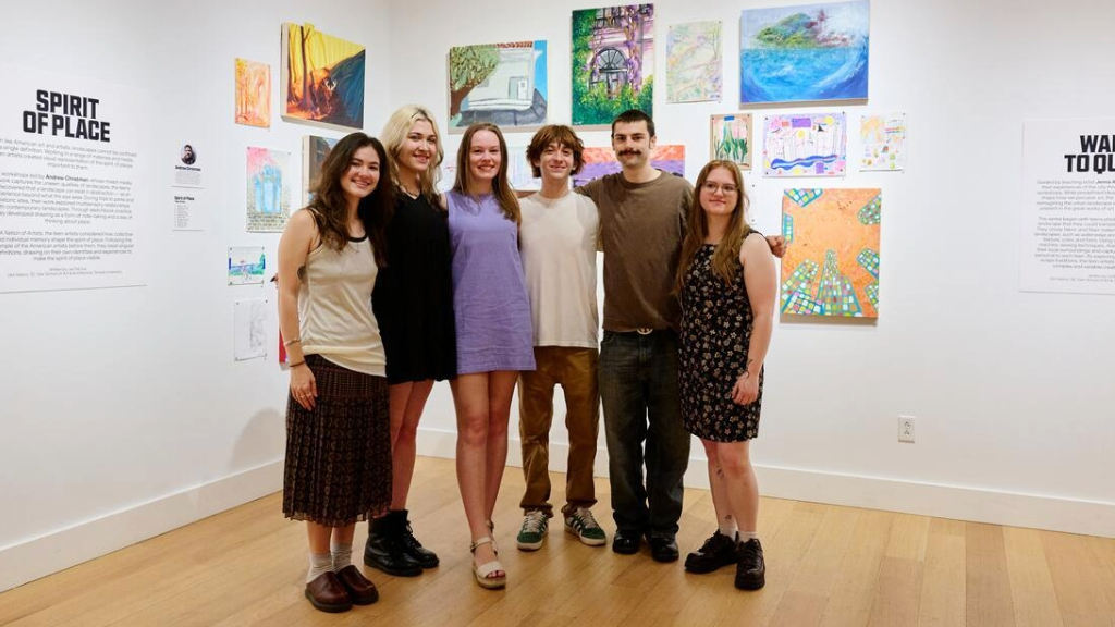 Tyler students pose in front of "A Future of Artists" exhibition.