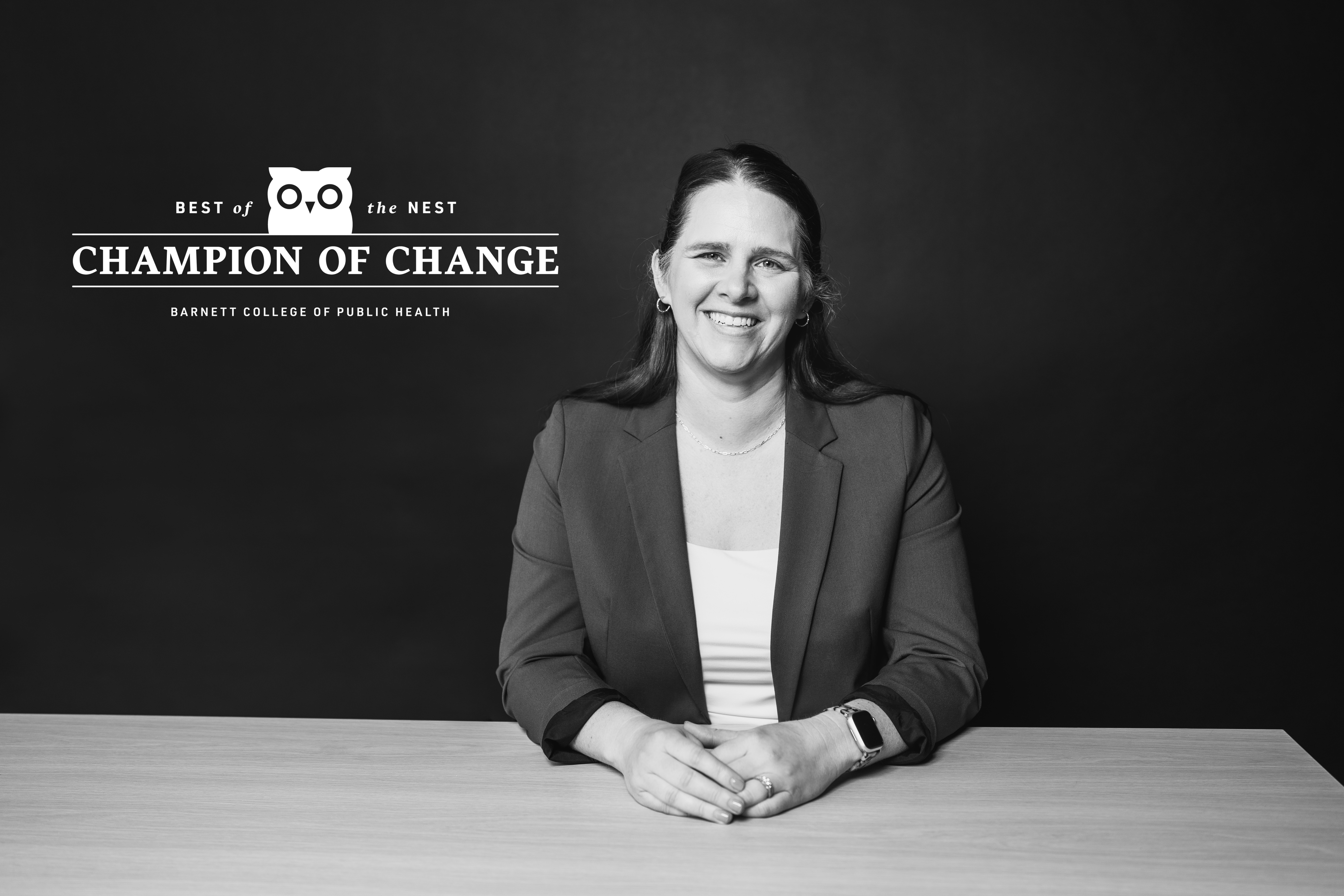 Black and white portrait of Anne Russ, seated and smiling.