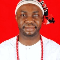 image of Chinedu wearing a white shirt and hat smiling at the camera