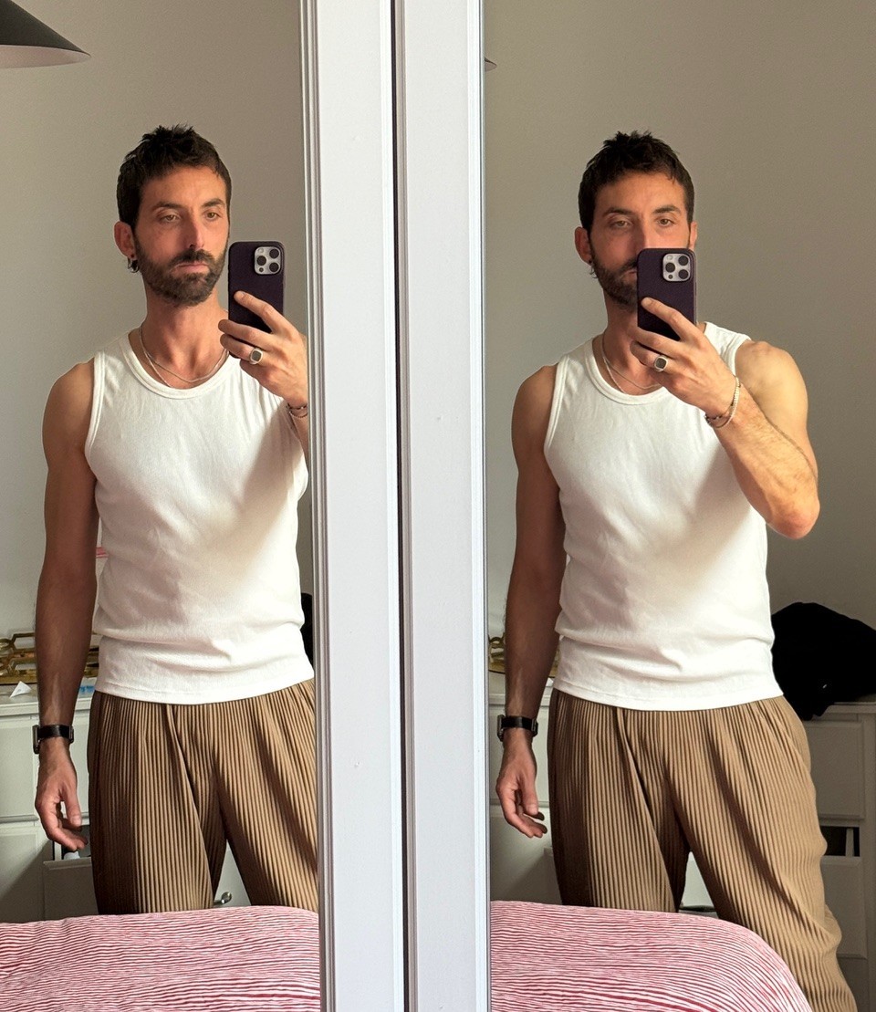 Prof. Damon Young - Taking a selfie - man with dark hair taking a picture in the mirror with a cell phone