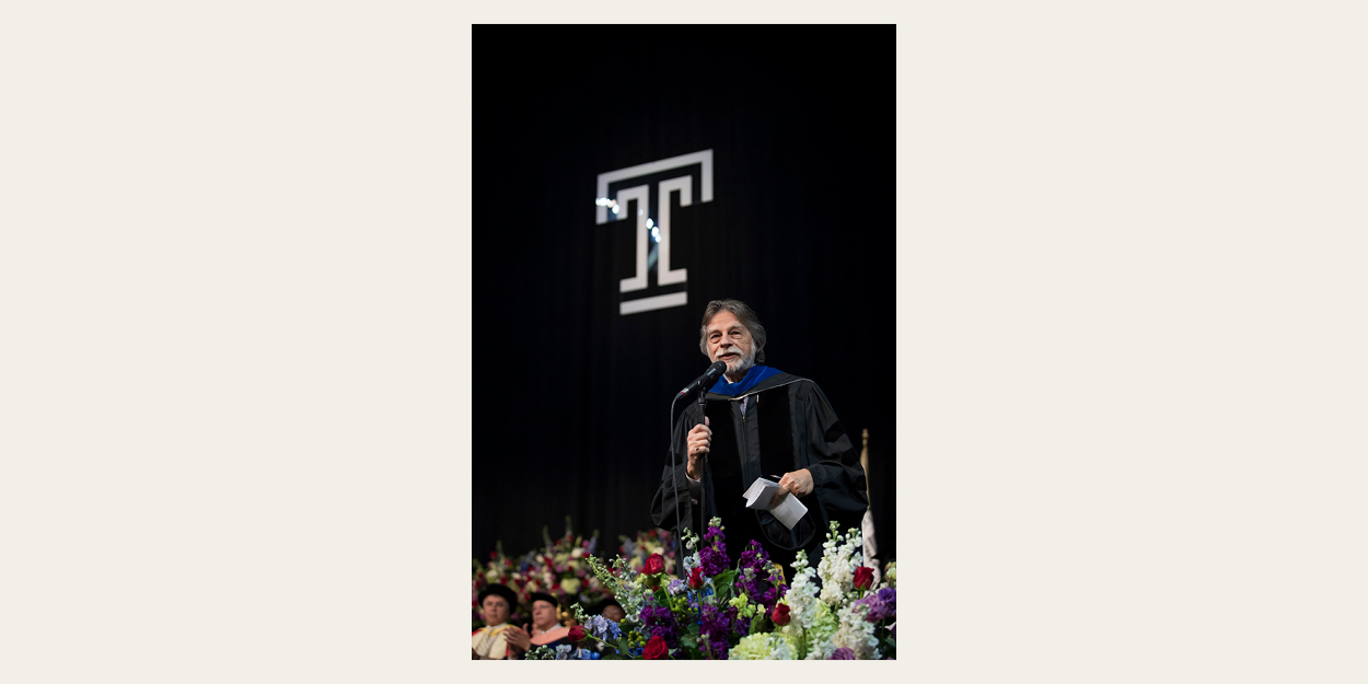Peter H. Doukas is pictured speaking at a Temple Commencement ceremony