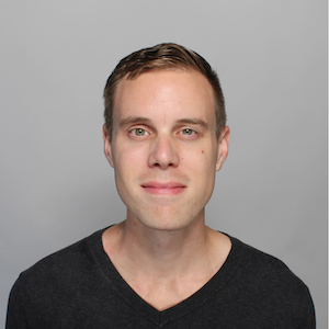 image of Ethan wearing a black t-shirt smiling into the camera