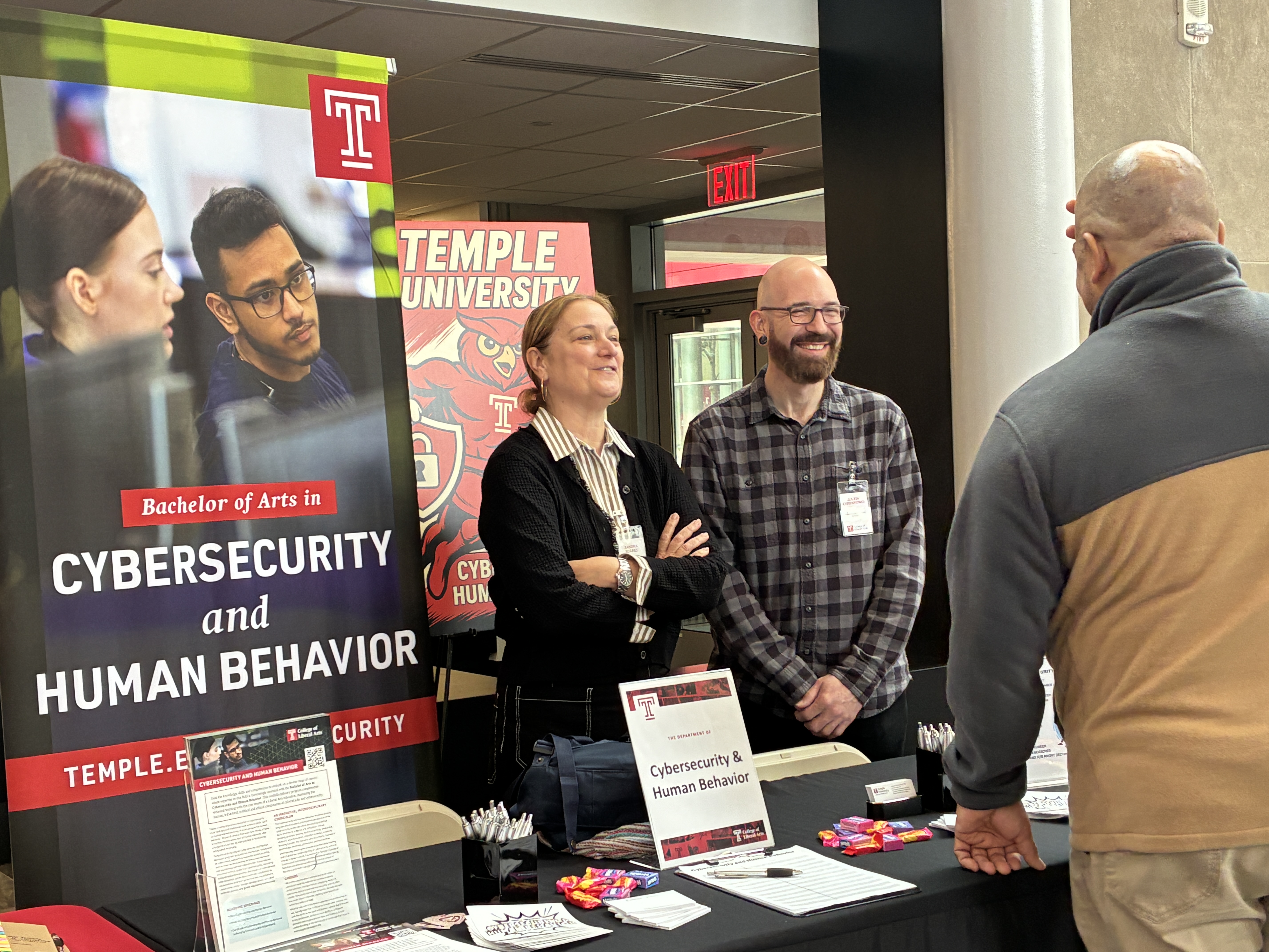 Julien Ehrenkönig and Sandra Suarez greet visitors at the Cybersecurity and Human Behavior's table at Experience Temple Day.